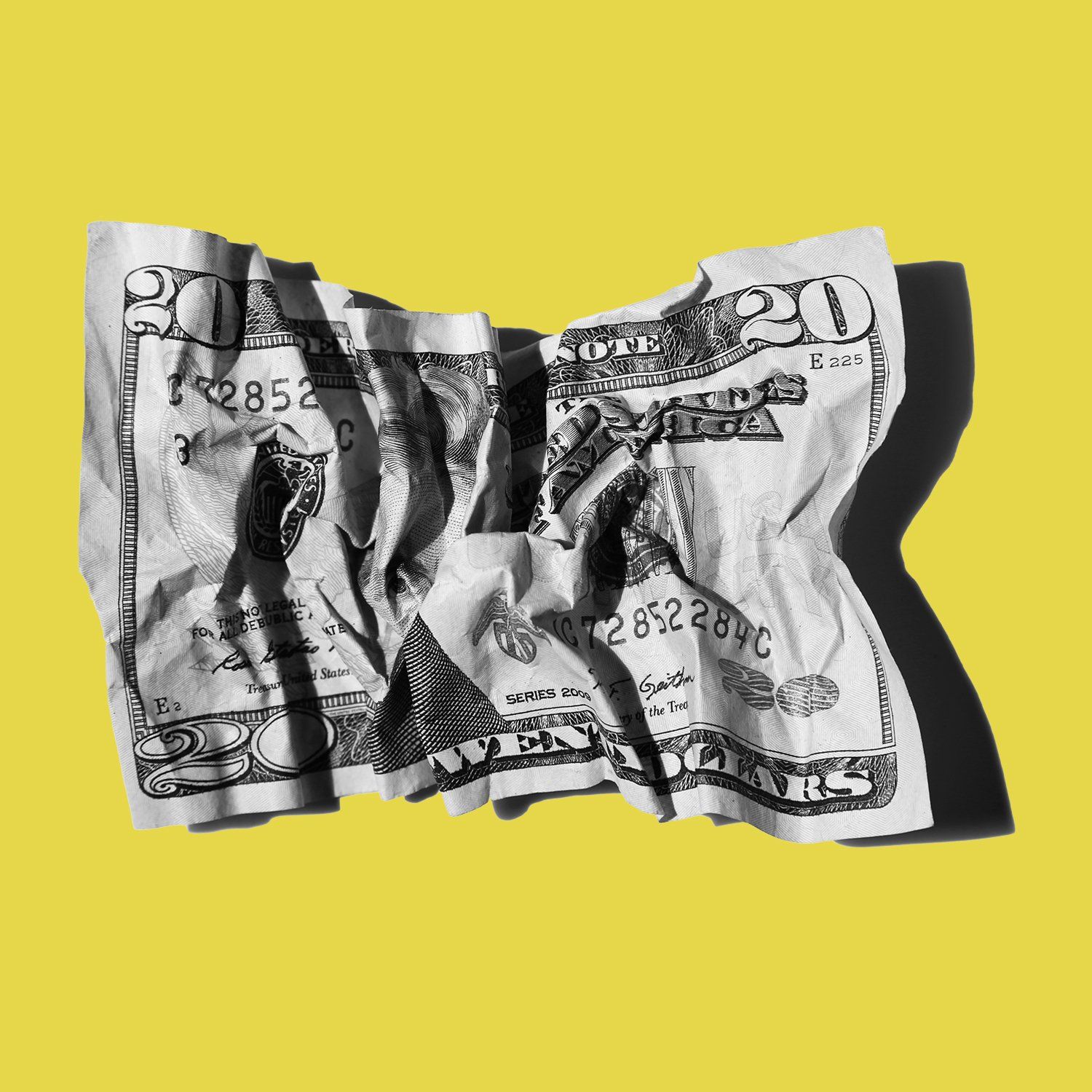 An image of a crumpled twenty dollar bill on a bright yellow background.