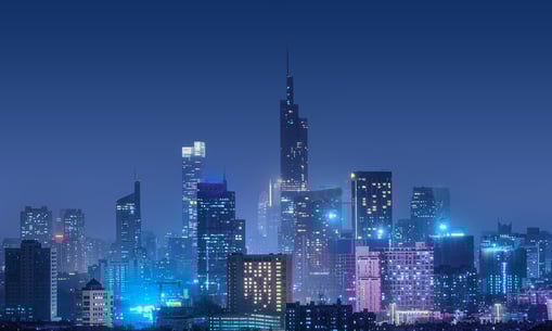 A futuristic city skyline and a person using a smartphone representing the future of PR
